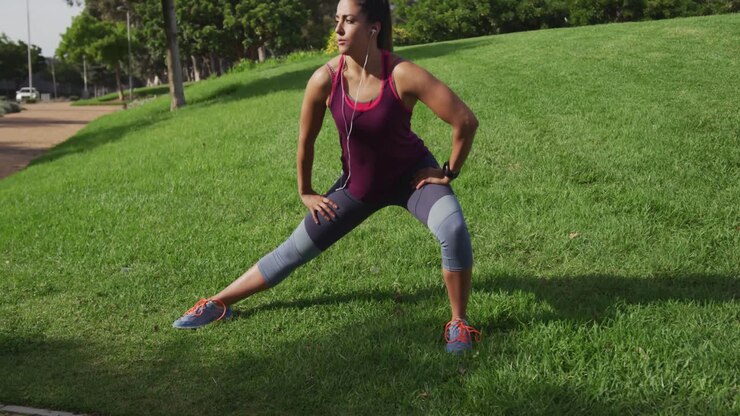 Caucasian woman stretching in a park