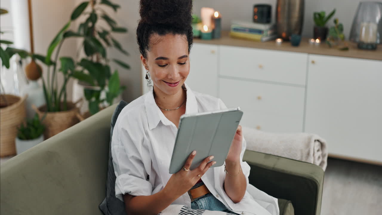 Woman using tablet on couch