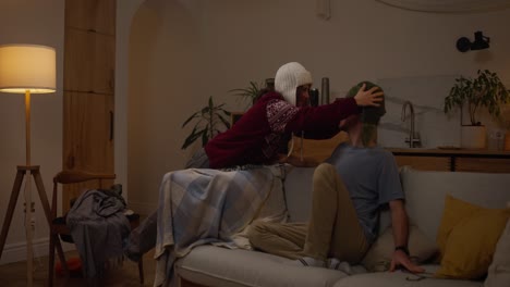 couple in cozy winter clothes at home
