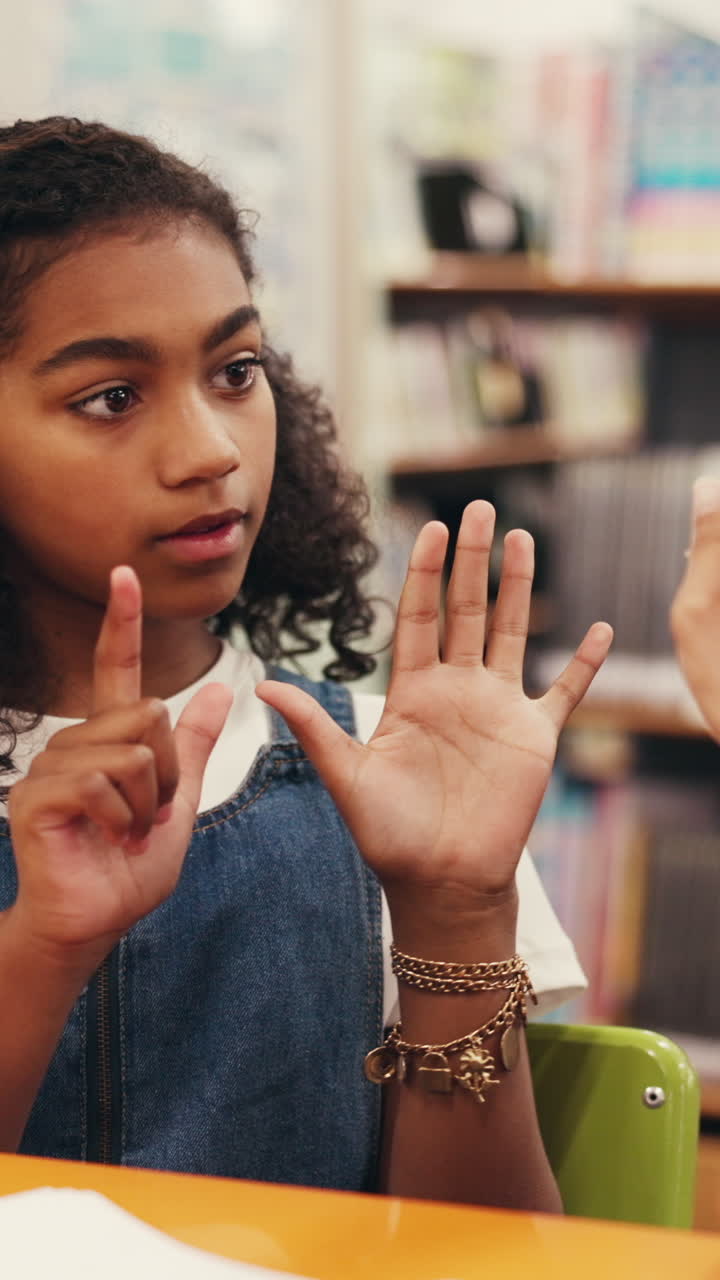 Young Girl Counting on Her Fingers While Learning in a Classroom