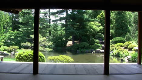 view of japanese garden and pond from inside japanese house with walls removed