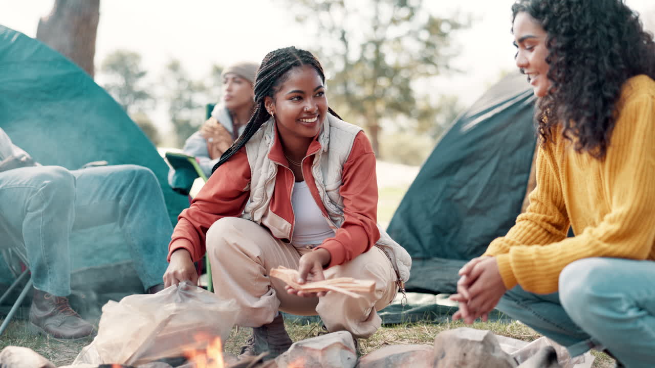 Friends camping around a campfire