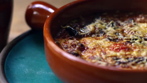 aubergine, feta and tomato bake in earthenware dish, zoom