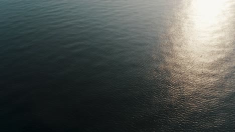 sunlight reflection on the water surface of playa de monterrico in guatemala