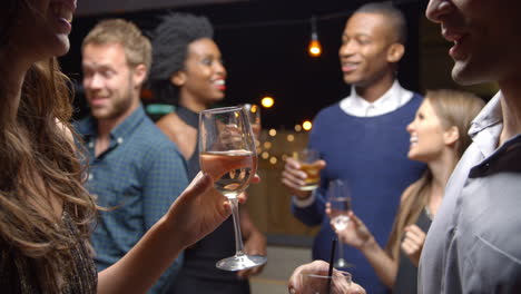 couples chatting and drinking at evening party, slow motion
