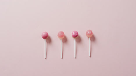 video of pink lollipops on pink background