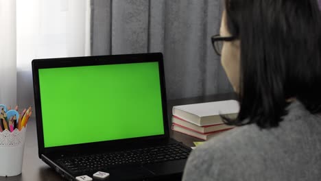 Woman-teacher-making-online-distance-education-video-call-on-laptop-green-screen