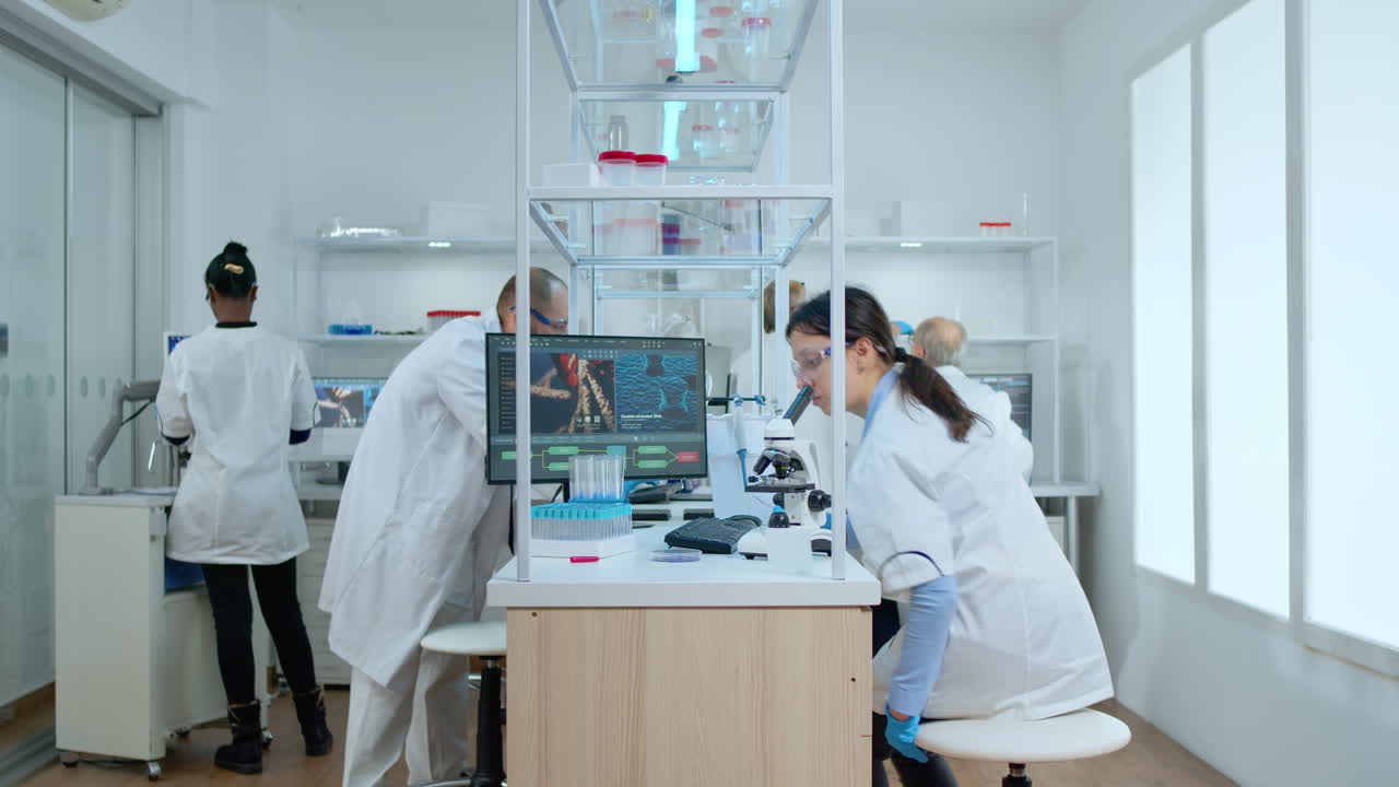 Scientist analyzing vaccine result in laboratory with microscope