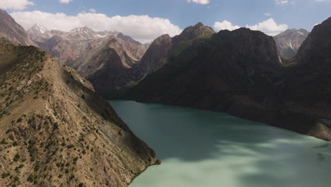 iskanderkul lake surrounded by mountainscape in sughd province, tajikistan