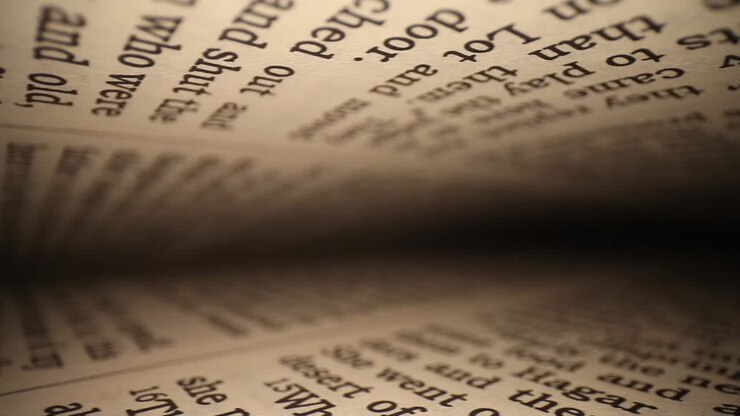 moving diagonally through a book left to right, pages on top - bottom of frame as it passes down to the end