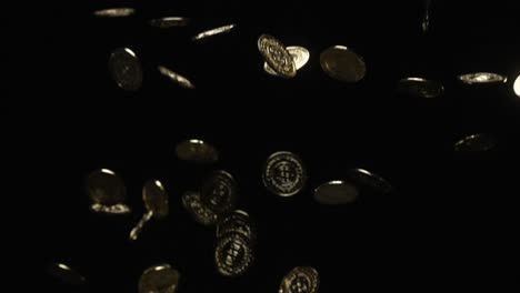 many gold coins falling in slow motion