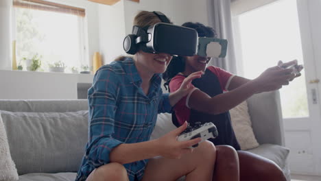 Happy-diverse-teenage-female-friends-playing-video-games-with-vr-headsets-at-home,-slow-motion