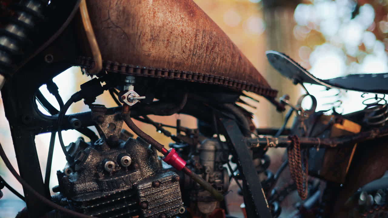 Close up of a vintage rusty motorcycle parked on a city street