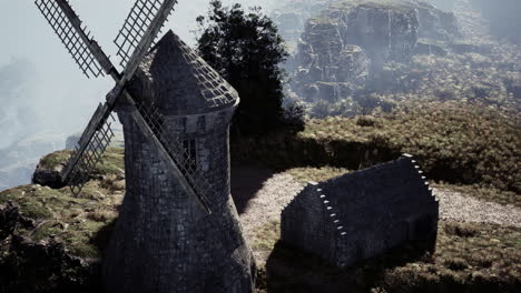 ancient windmill and cabin on a mountain ridge