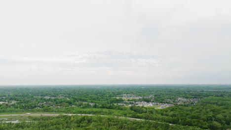 Expansive-aerial-view-of-Wolf-River-flowing-through-Collierville,-Tennessee,-with-lush-greenery