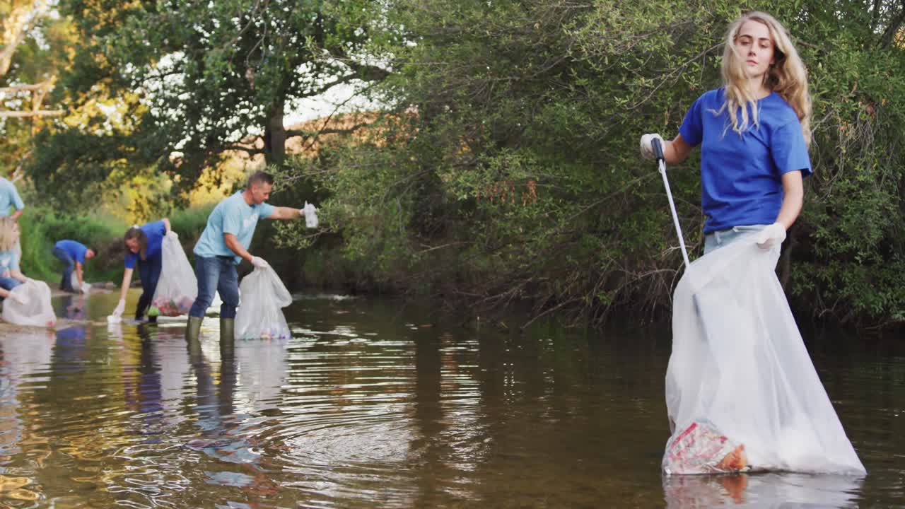Mid adults volunteering during river clean-up day
