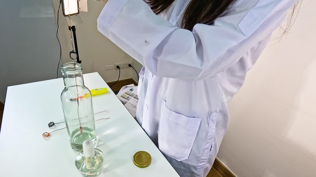 Scientist conducts copper-acetone oxidation experiment in a lab setting. Bright lighting, close-up shots, and precise movements highlight the process