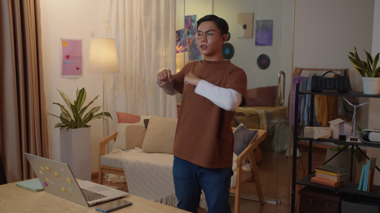 Male Asian Student Doing Warm Up after Online Class at Home