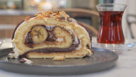 delicious chocolate and banana roll cake with a cup of turkish tea