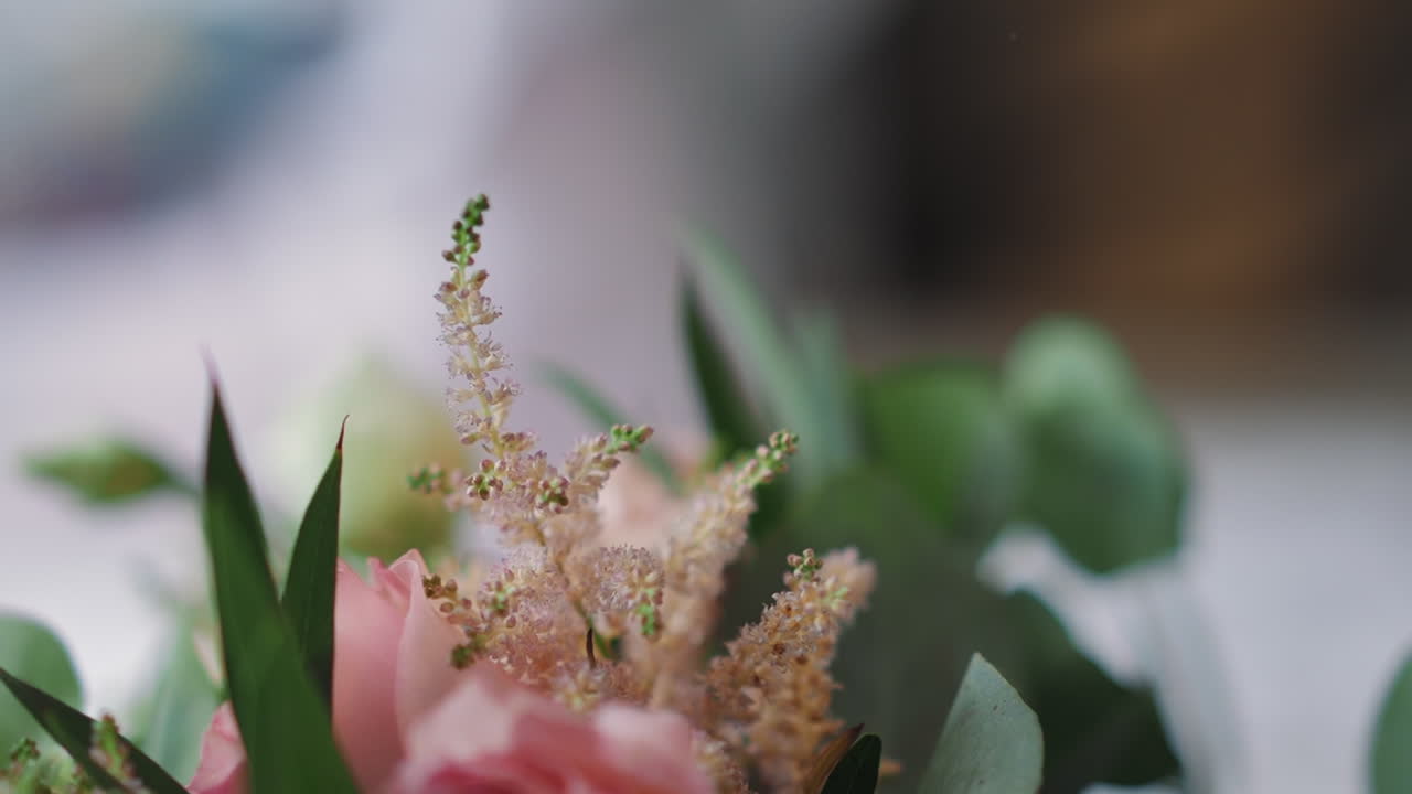 Bouquet with eustomas and windflowers on fuzzy background