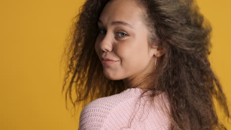 Caucasian-curly-haired-woman-winking-and-smiling-to-the-camera.