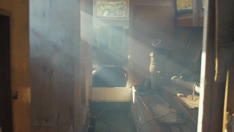 rays of sunshine illuminate smoke wooden boat cabin interior