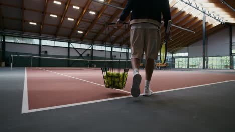 tennis player training on indoor court