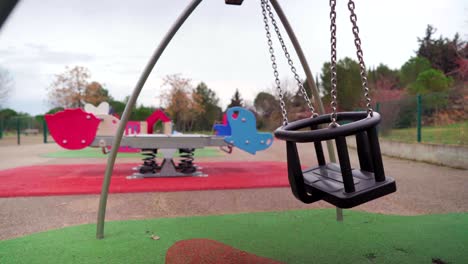 Empty-baby-swing-in-a-children-playground-during-Covid-19-coronavirus-pandemic-lockdown