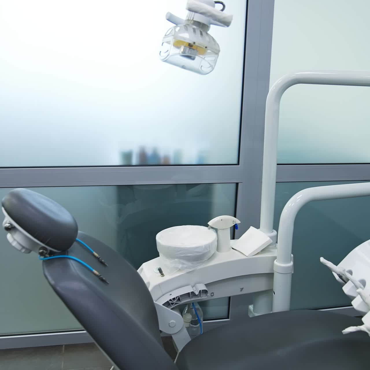 Armchair in modern dentistry clinic under the lamp. Clean and disinfected space for stomatology problems solving