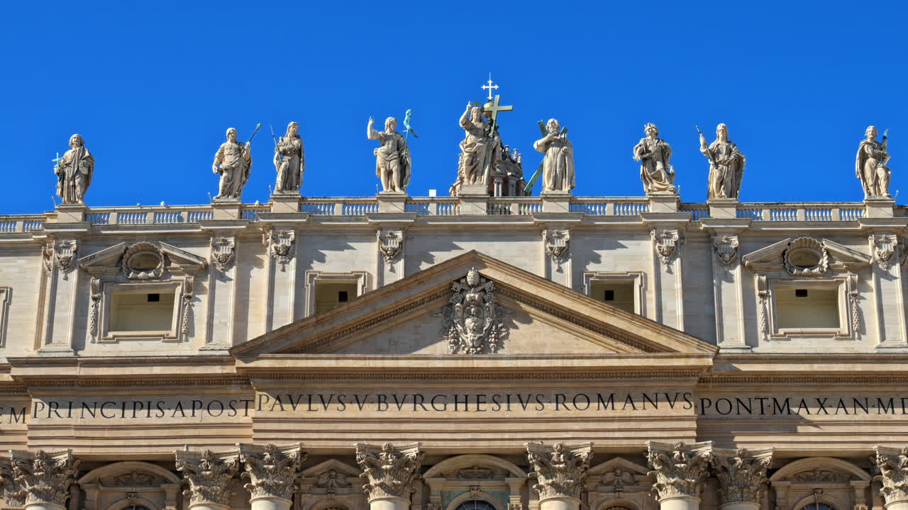 Statues on the Facade of St. Peter's Basilica on the blue sky background, in St. Peter's Square, Vatican City, Rome, Italy