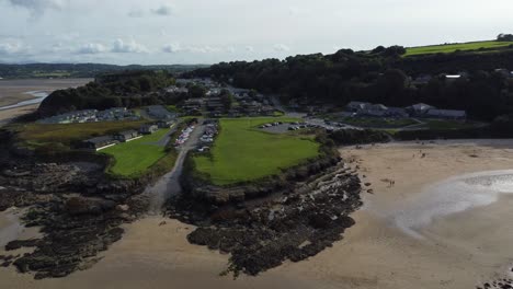 Aerial-view-descending-to-Red-wharf-bay-coastal-tavern-restaurant-on-the-isle-of-Anglesey,-North-Wales