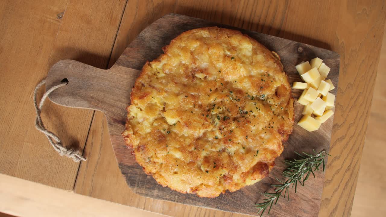 colpo di omelette fatto di formaggio, patate e uova, piatto di legno decorato