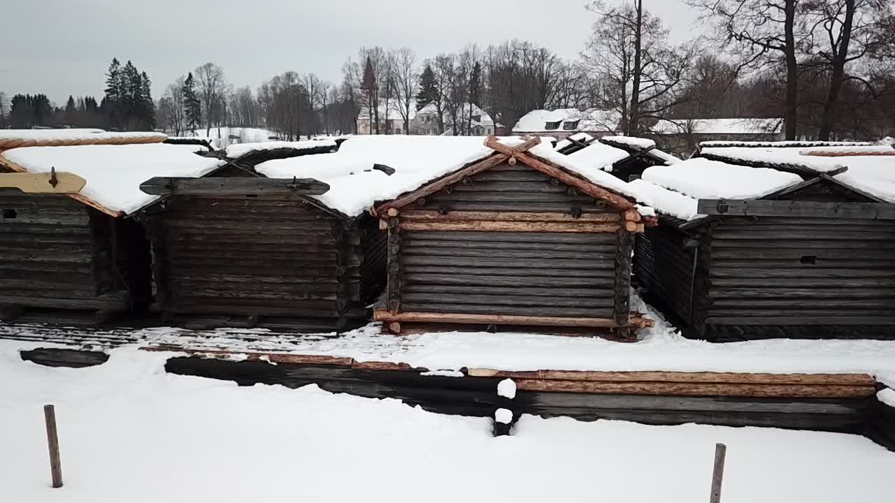 Snow Covered Roof Of Dwelling Houses In Araishi Archaeological Park In Latvia