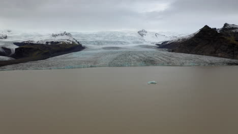 Aerial:-Panoramic-view-of-Fjallsarlon-glacier-lagoon-in-Iceland-during-an-overcast-day