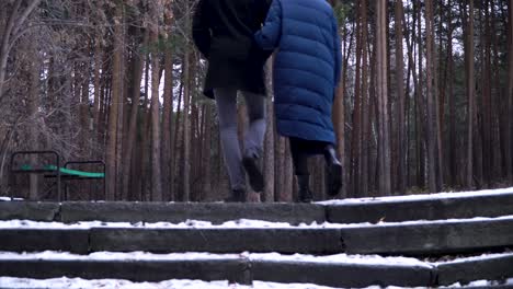 couple walking in a snowy forest