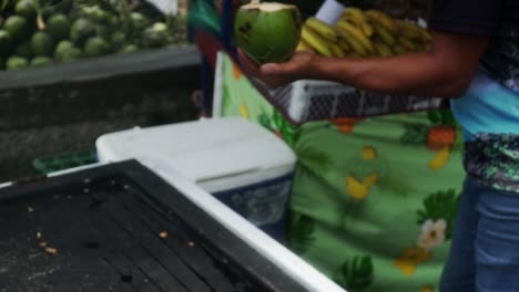 Man-chopped-the-top-off-a-green-coconut-with-a-machete-then-adds-a-plastic-straw