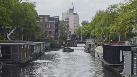 boat moving over canal in amsterdam city center