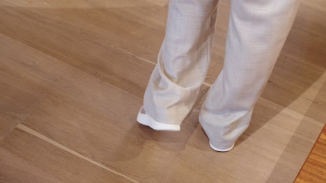 Woman-looking-at-shoes-she's-trying-on-at-a-clothing-store