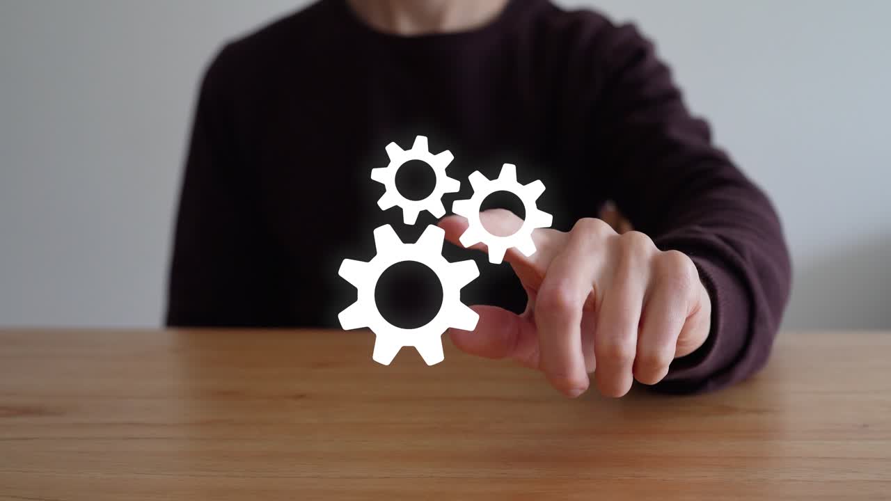 Person Touch The Three Interlocking Gear Icons That Represent Configuration. - clsoeup shot