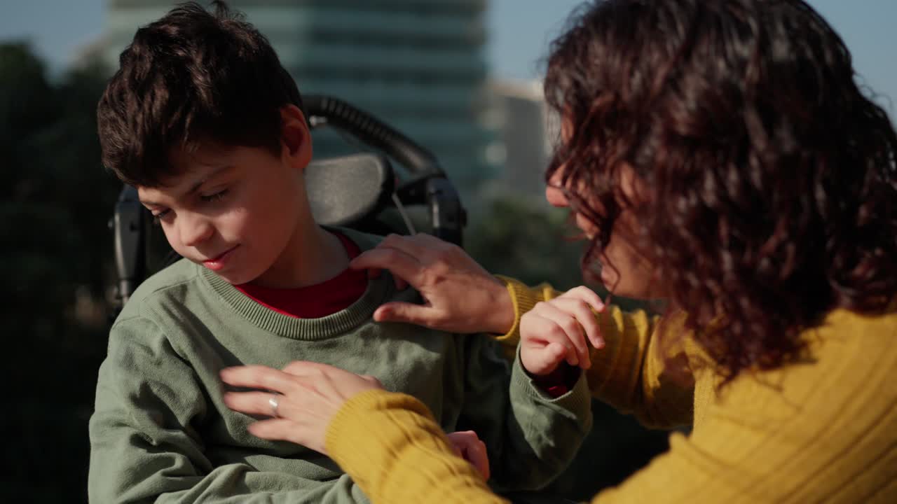 Mother and son with disability spending time together outdoors