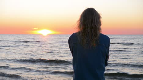 moving view of female standing near the sea