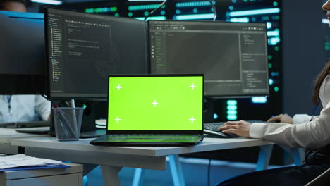 Woman-doing-maintenance-on-server-room-infrastructure-using-mockup-laptop