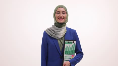 Professional woman in hijab holding a finance report