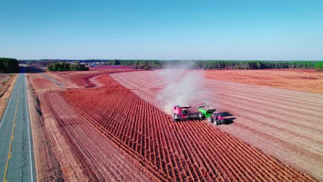 soybean combine red harvester with tractor for unloading soybeans while driving