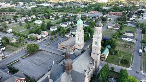 An-aerial-view-of-the-Saint-Stanislaus-B-and-M-Roman-Catholic-Church-spires-in-Buffalo,-New-York-in-the-light-of-the-setting-sun