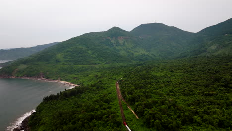 train and railway on hai van pass in vietnam - aerial drone shot