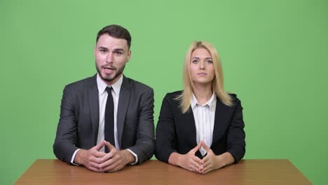 Young businessman flirting with young businesswoman while working