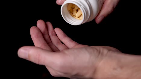 prescription drugs being poured into a drug addict's hand, close-up slow motion