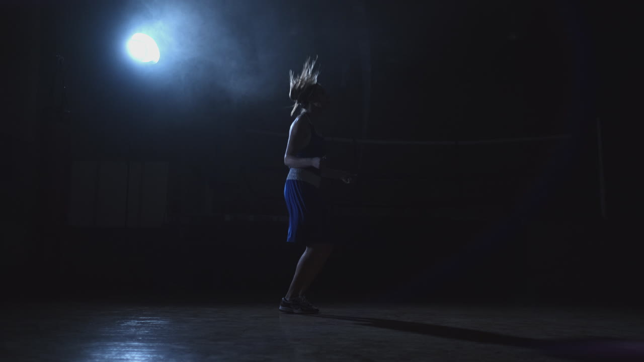 General plan of the gym Boxing gym with a ring and a young beautiful woman jumping rope