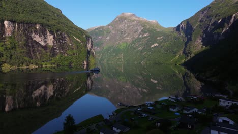 Aerial-View-Above-Cabins-in-Geirangerfjord-as-Ferry-brings-Tourists-on-Fjord-Cruise-from-Geiranger-to-Hellesylt,-Norway